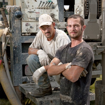 Men with well water drilling equipment