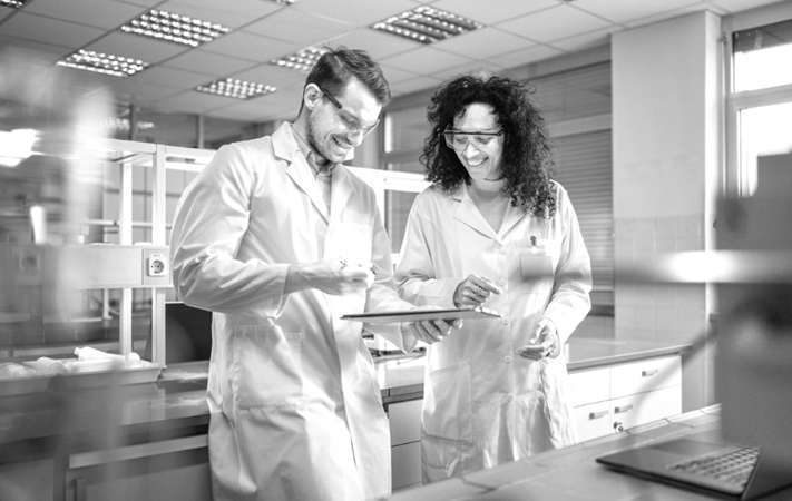 man and woman in lab coat